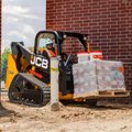 JCB 215T Compact Track Loader hauling construction supplies