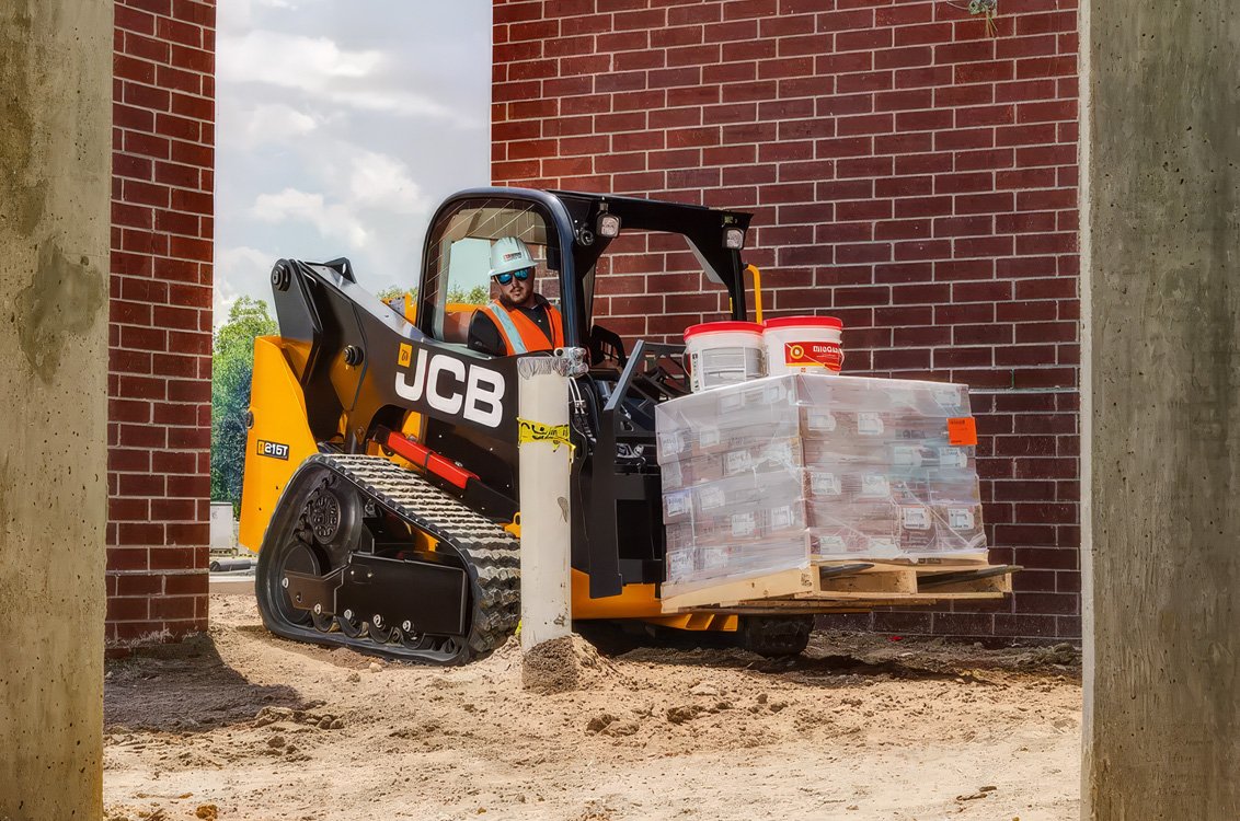 JCB 215T Compact Track Loader hauling construction supplies