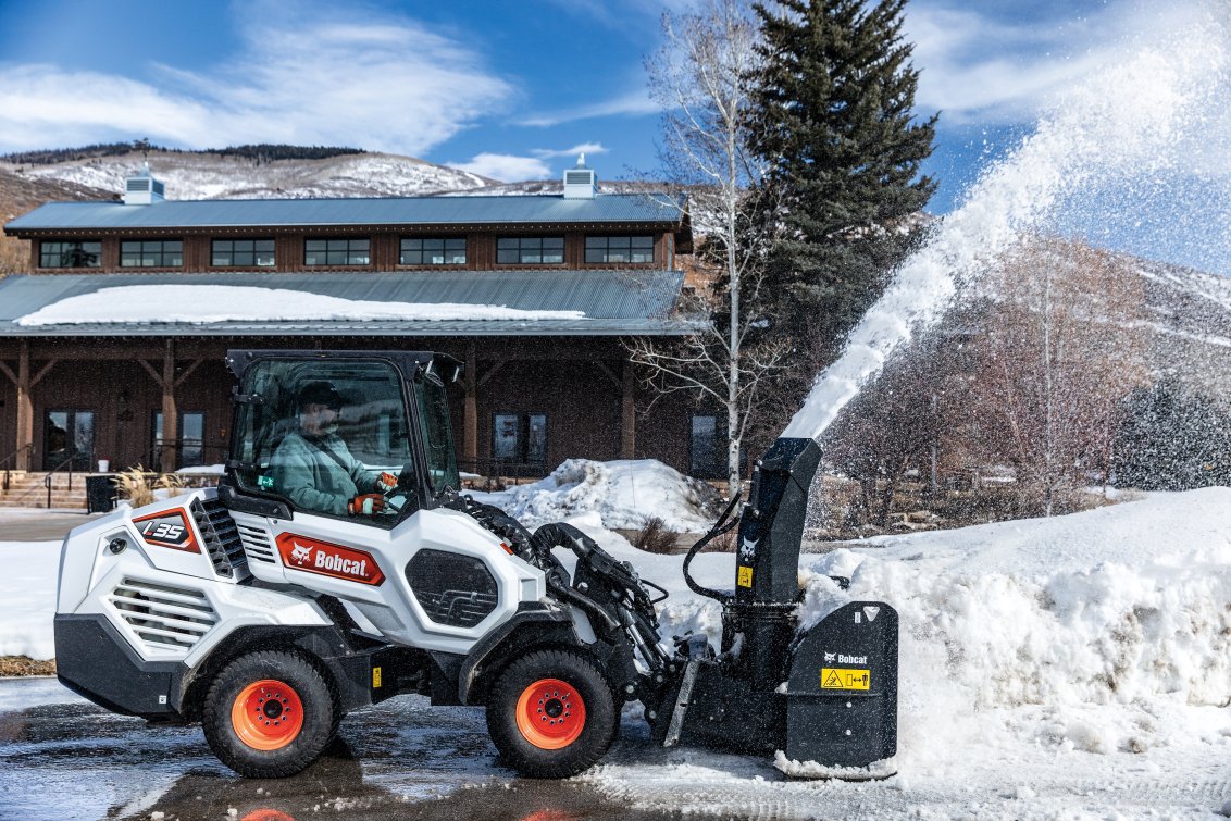 Bobcat L35 Small Articulated Loader clearing snow from a parking lot