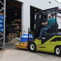 Clark SE25 Electric Rider Pneumatic Forklift driving into a warehouse