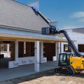 JCB 400T Compact Track Loader lifting roofing material