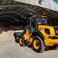 JCB 411 Wheel Loader scooping up a bucket of sand