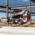 Bobcat S86 Skid Steer hauling construction material
