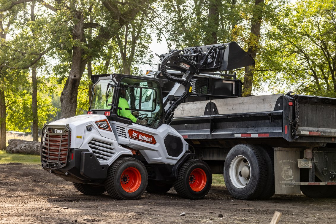 Bobcat L35 Small Articulated Loader dumping dirt into truck