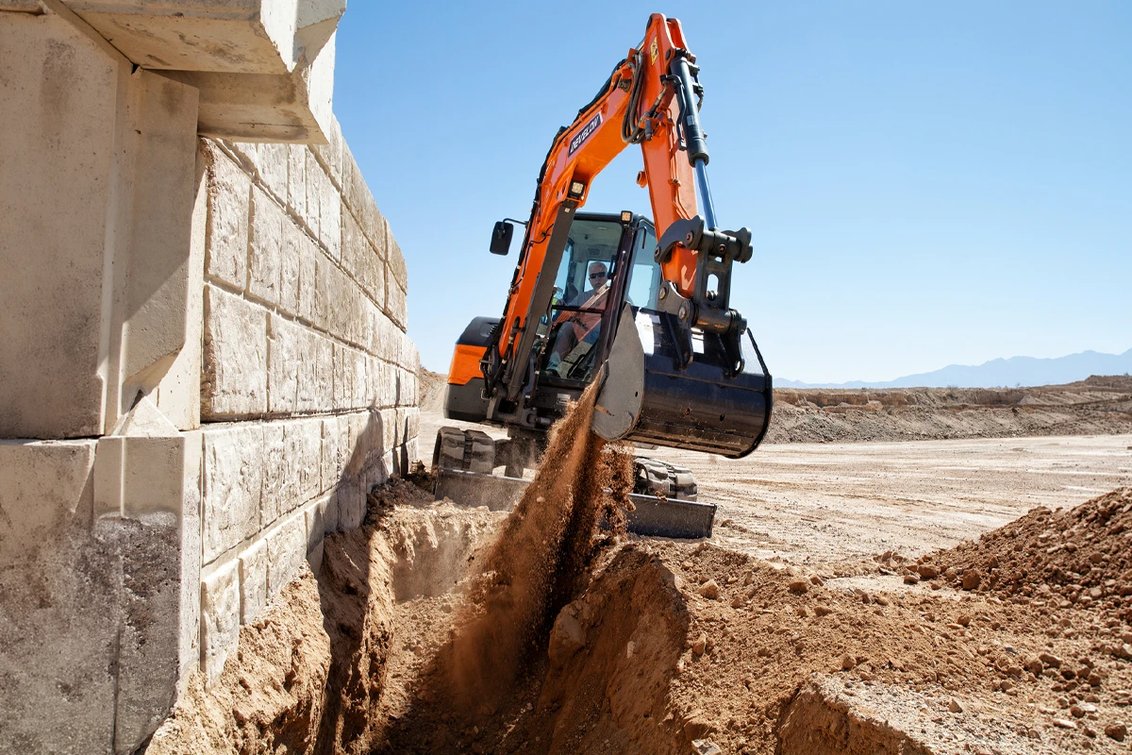 DEVELON DX55R-7 Mini Excavators digging a trench