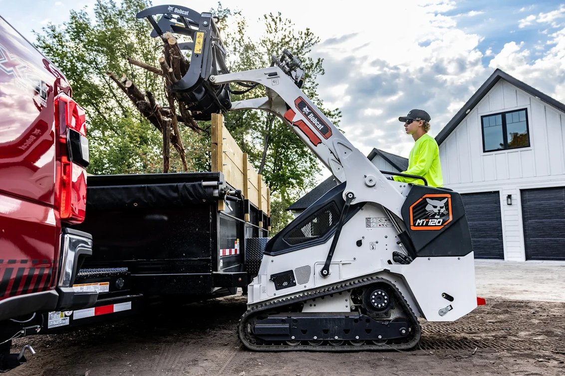 Bobcat MT120 Mini Track Loader dumping debris