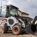 Bobcat L28 Small Articulated Loader moving landscape rocks