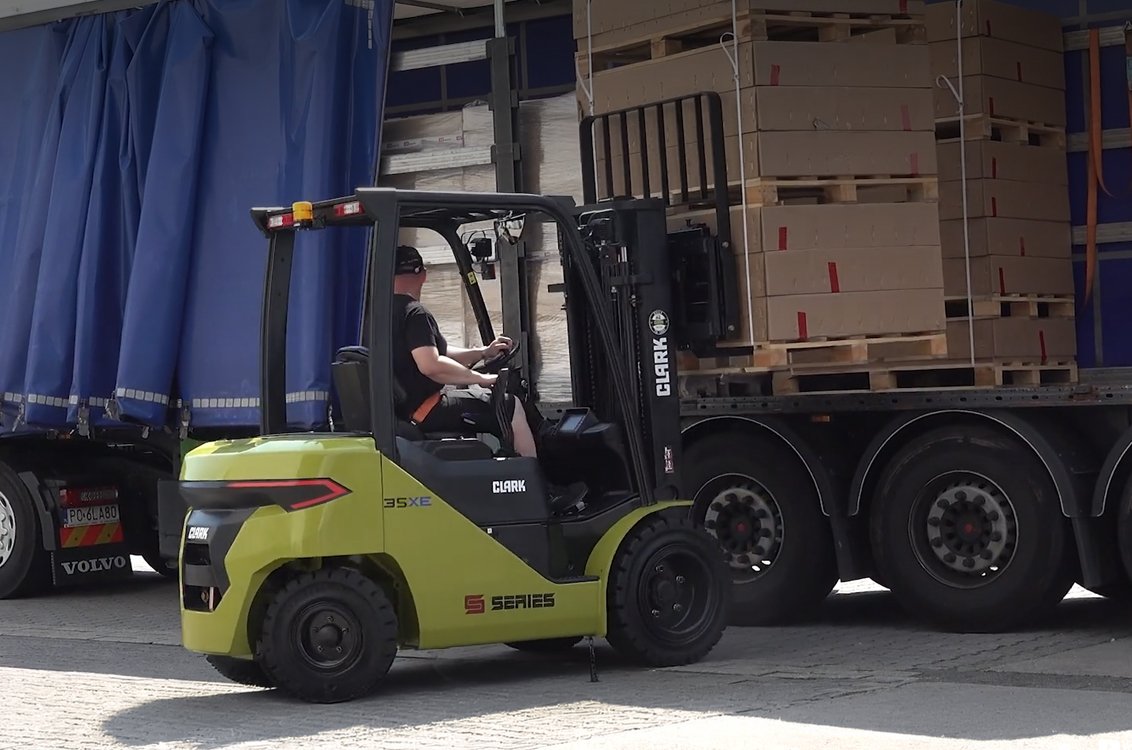 Clark S35XE Renegade Electric Rider Pneumatic Forklift unloading a freight truck