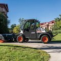 Bobcat UW53 Toolcat sweeping a sidewalk