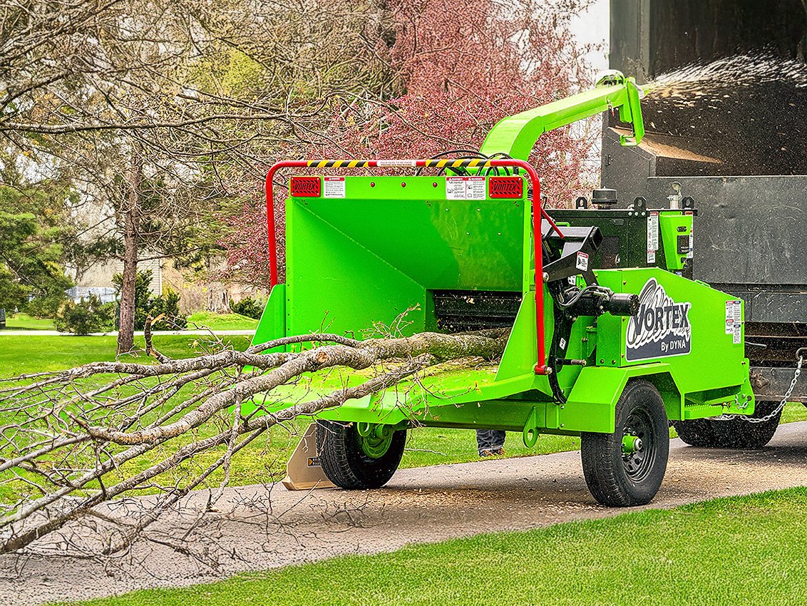 VORTEX V12-31 Wood Chipper grinding a small tree and blowing chips into a truck