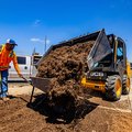 JCB 215 Skid Steer Loader dumping soil