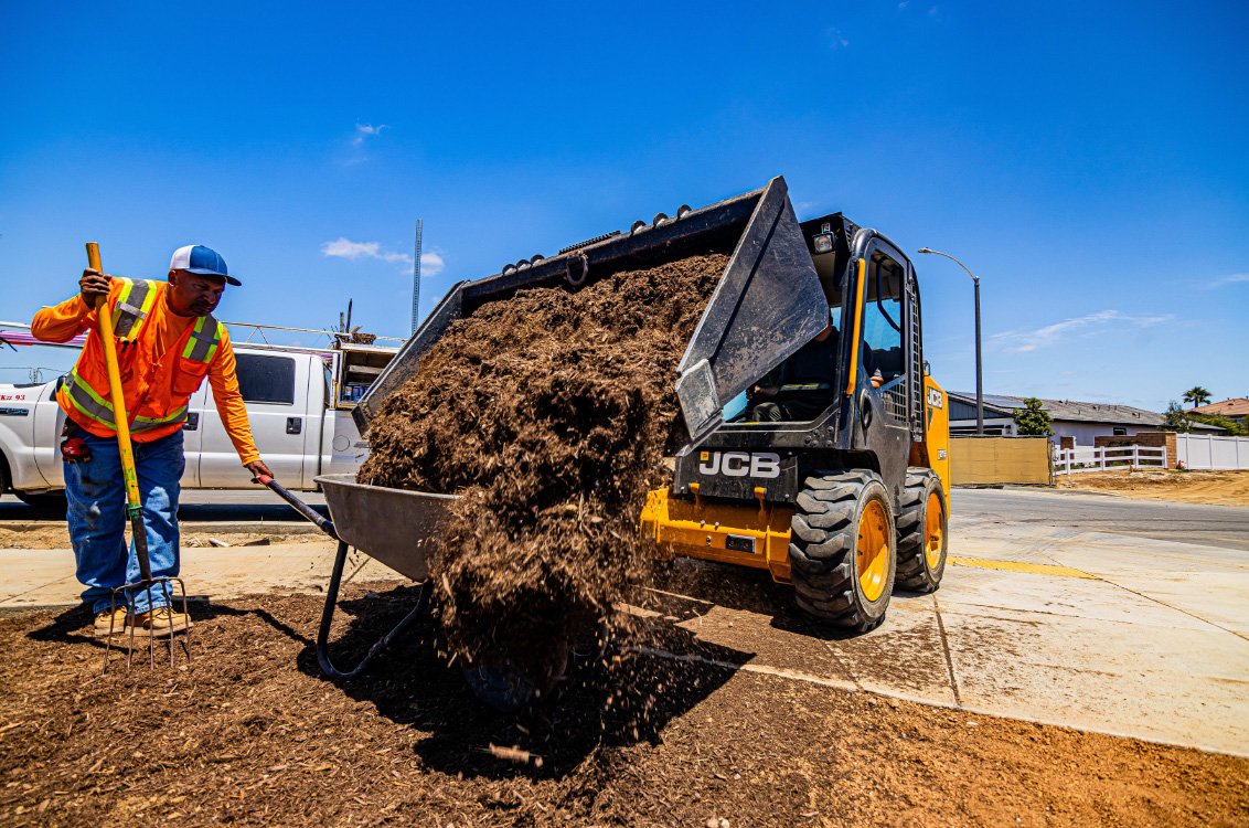 JCB 215 Skid Steer Loader dumping soil