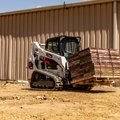 Bobcat T595 Compact Track Loader hauling heavy material