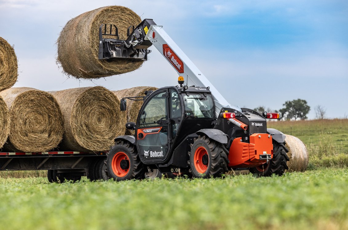 Bobcat TL623 Telehandler stacking large rolls of hay