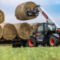 Bobcat TL623 Telehandler stacking large rolls of hay