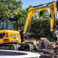 JCB 100C-2 Mini Excavator moving large stones