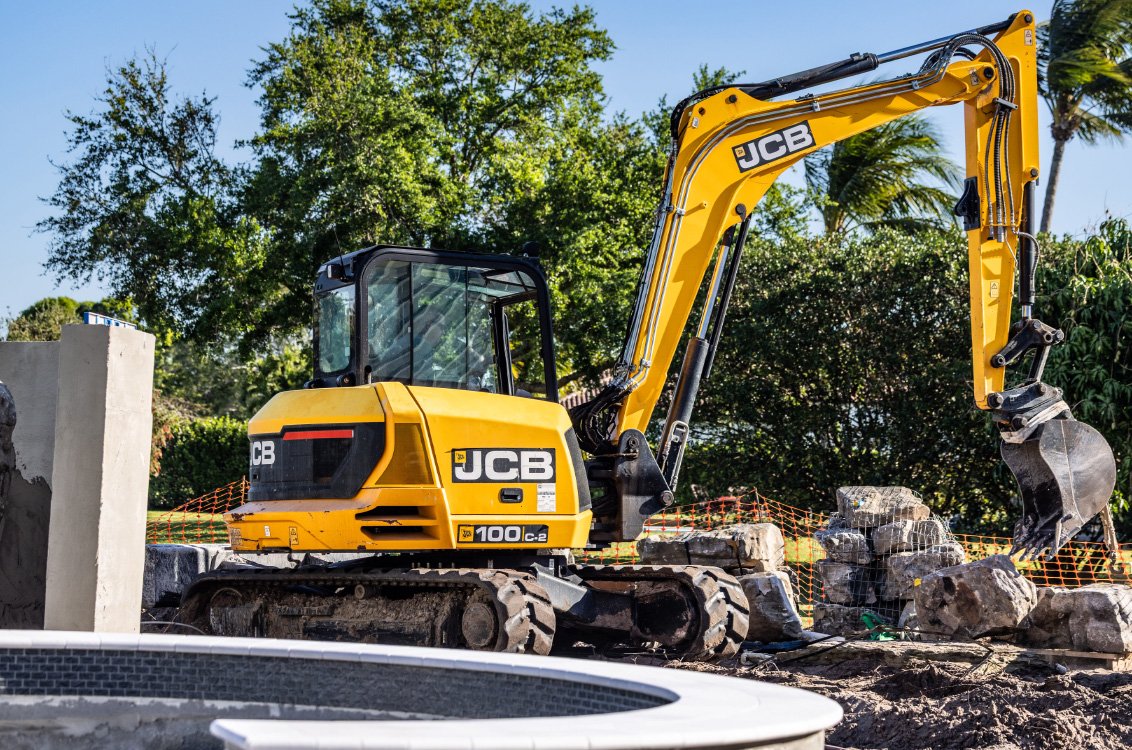 JCB 100C-2 Mini Excavator moving large stones
