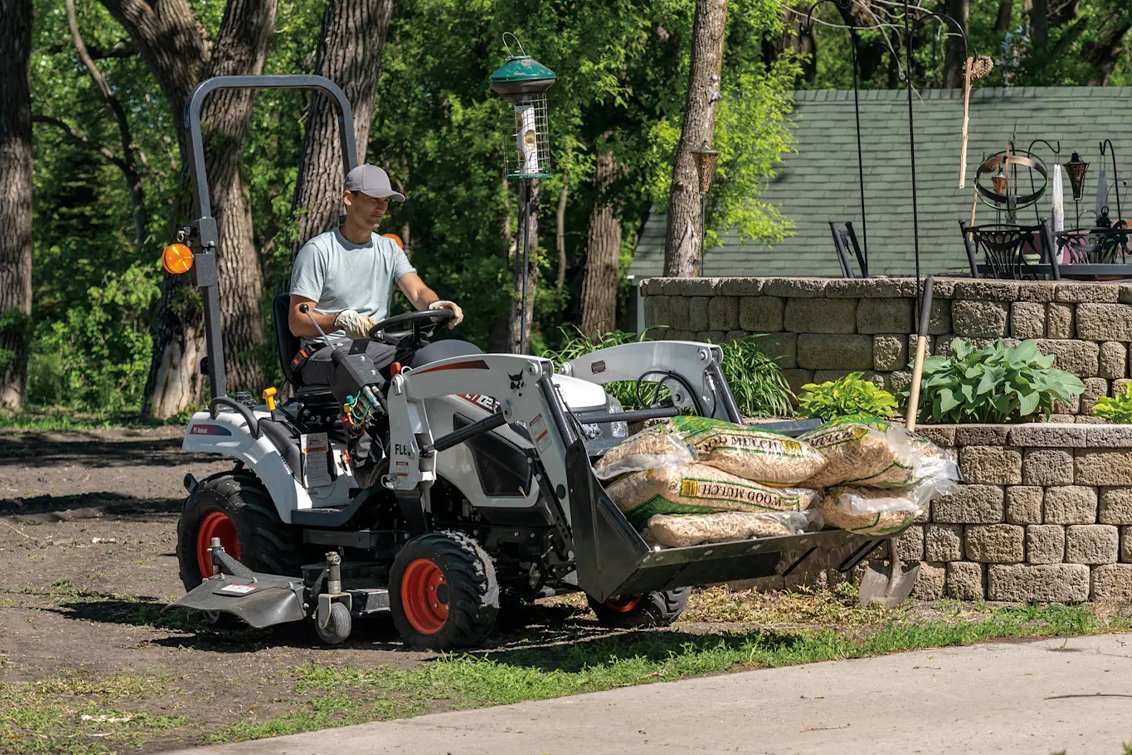Bobcat CT1025 HST Sub-Compact Tractor hauling wood mulch