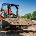 JCB 215T Compact Track Loader moving sand