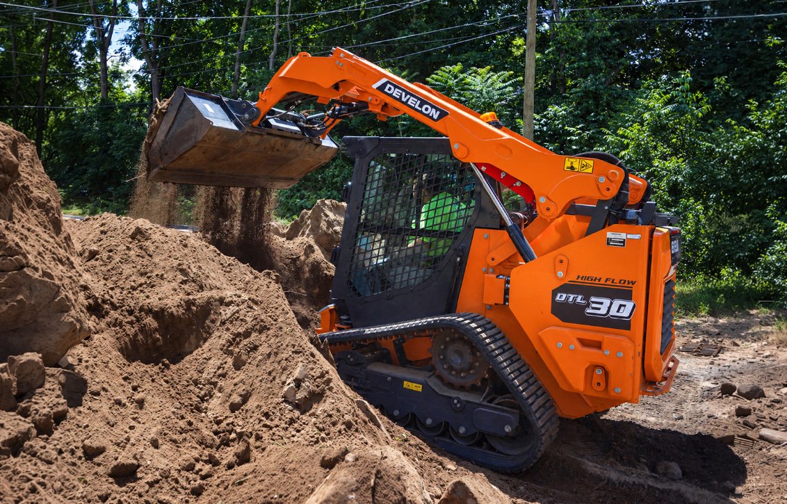 DEVELON DTL30 Compact Track Loader dumping dirt