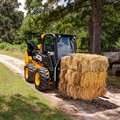 JCB 270 Skid Steer Loader hauling hay bales