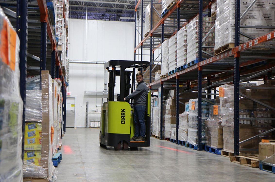 Clark SES17 Electric Stand-Up Cushion Forklift in a warehouse