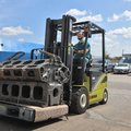 Clark SE35 Electric Rider Pneumatic Forklift moving a large heavy engine