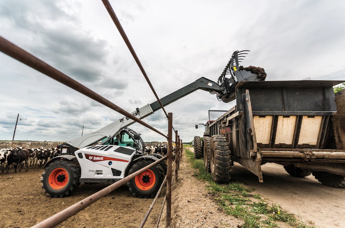 Bobcat TL723 Telehandler unloading farm waste into a container