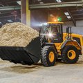 JCB 427 Wheel Loader hauling wood shavings