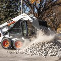 Bobcat S450 Skid Steer Loader dumping rocks
