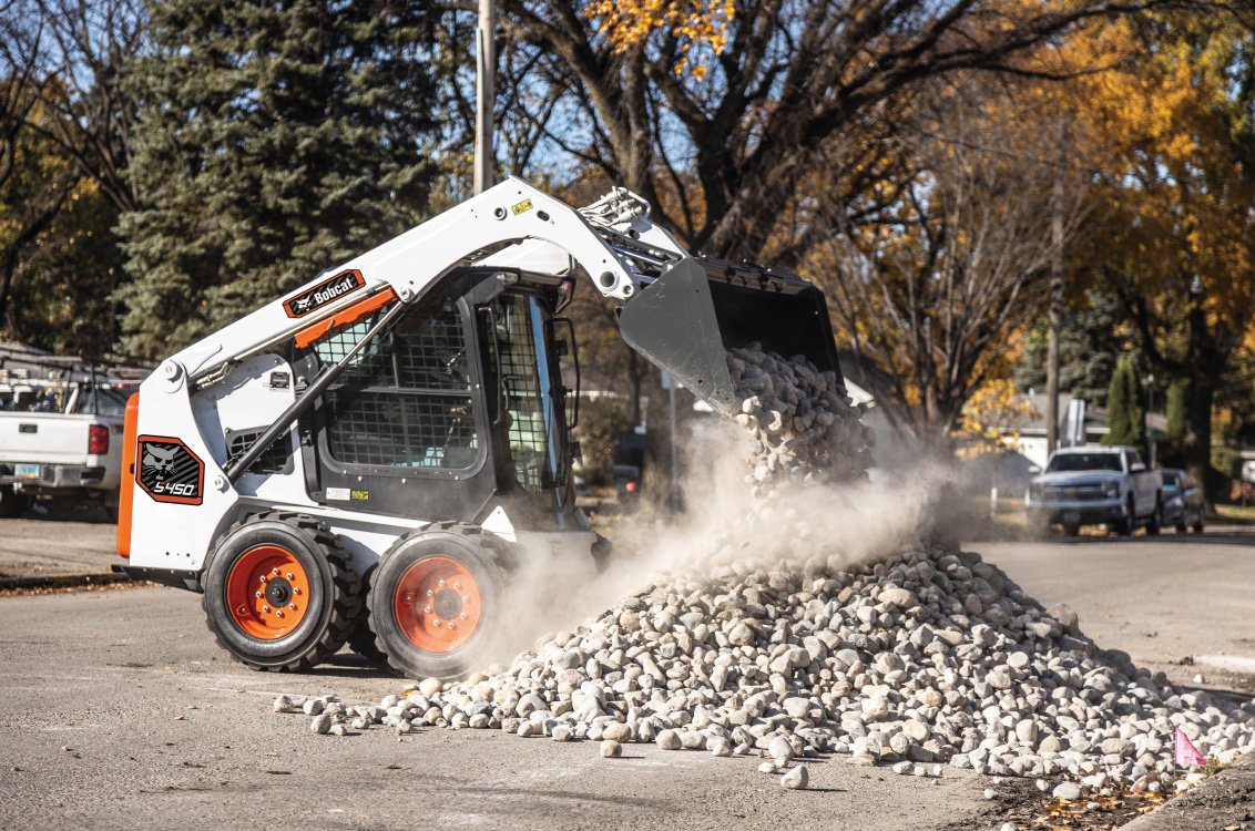 Bobcat S450 Skid Steer Loader dumping rocks
