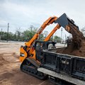 DEVELON DTL35 Compact Track Loader dumping dirt