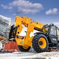 JCB 512-56 Telehandler hauling a heavy load on a construction site
