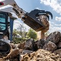 Bobcat T66-2 Compact Track Loader moving large stones