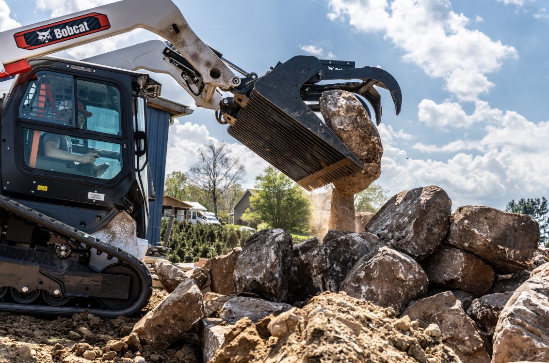 Bobcat T66-2 Compact Track Loader moving large stones