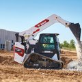 Bobcat T86 Compact Track Loader dumping a load of rocks