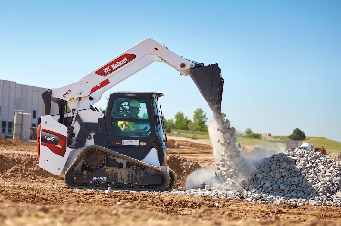 Bobcat T86 Compact Track Loader dumping a load of rocks