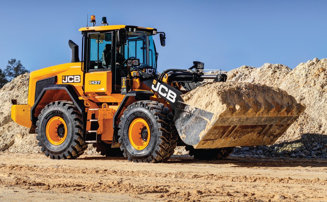 JCB 437 Wheel Loader hauling dirt on construction site
