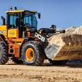 JCB 437 Wheel Loader hauling dirt on construction site