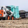 Bobcat S590 Skid Steer Loader hauling construction supplies