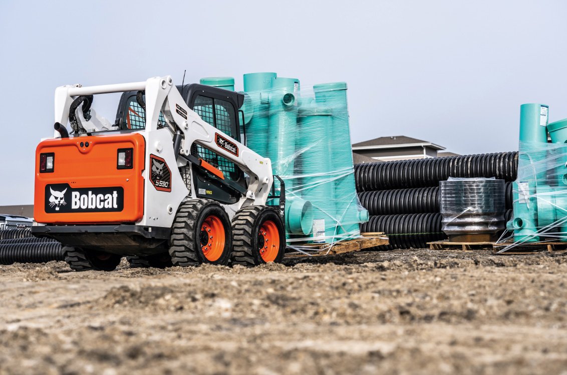 Bobcat S590 Skid Steer Loader hauling construction supplies