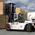 Bobcat DV250S-7 IC Pneumatic Forklift moving a large stack of wood products
