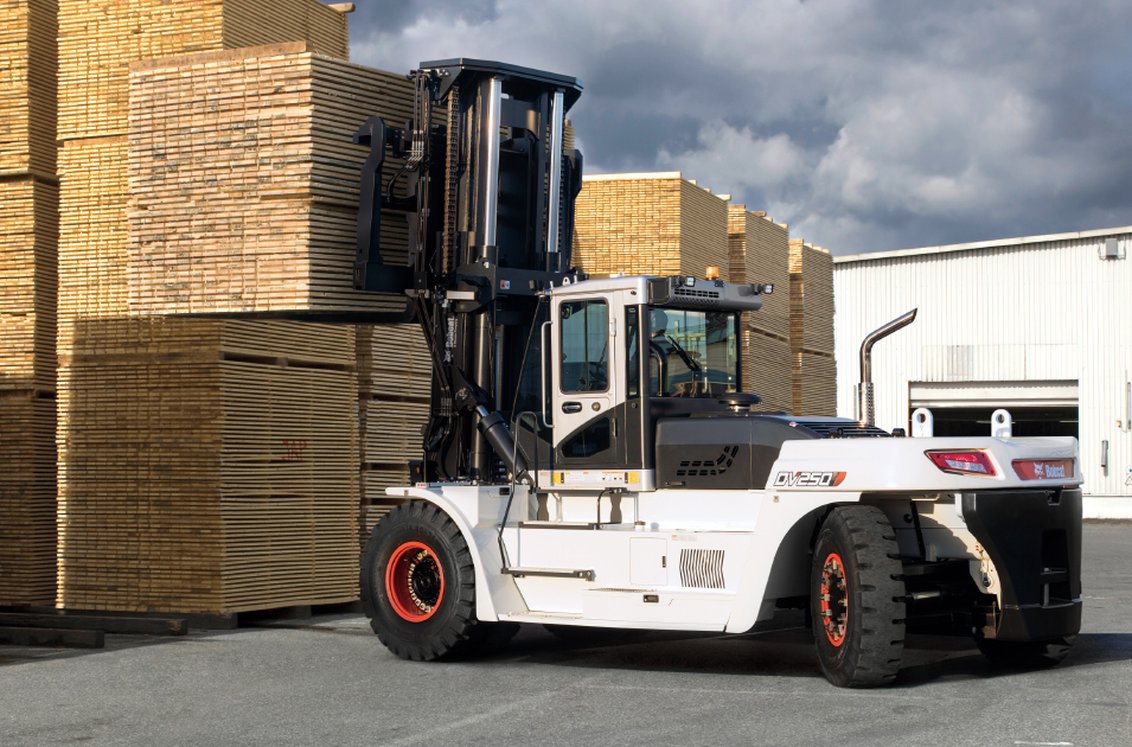 Bobcat DV250S-7 IC Pneumatic Forklift moving a large stack of wood products