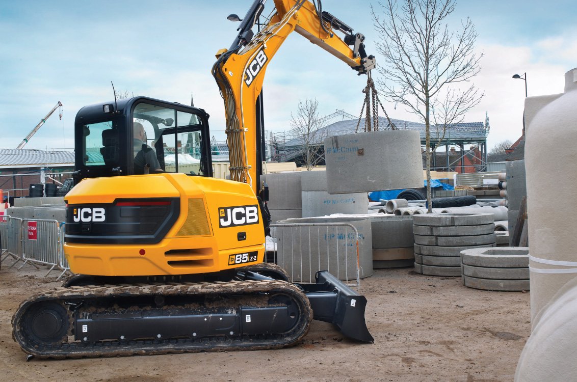 JCB 85Z-2 Mini Excavator lifting concrete pipes