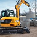JCB 85Z-2 Mini Excavator lifting concrete pipes