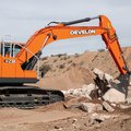 DEVELON DX230LC-9 Crawler Excavator digging rocks