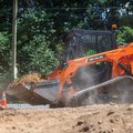 DEVELON DTL26 Compact Track Loader hauling dirt