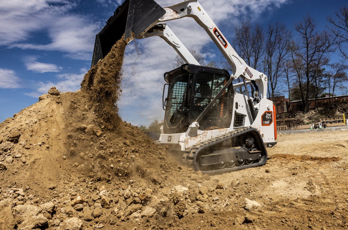 Bobcat T595 Compact Track Loader dumping a load of dirt