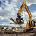 JCB 245XR Crawler Excavator hauling scrap wood