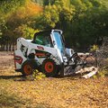 Bobcat S650 Skid Steer Loader cleaning brush debris